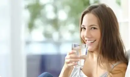 woman serving a glass of water